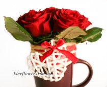 The composition of red roses in a cup